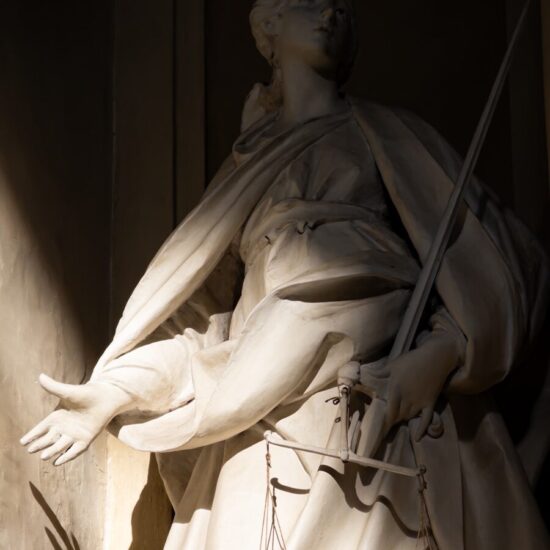 Statue of justice holding scales and sword.